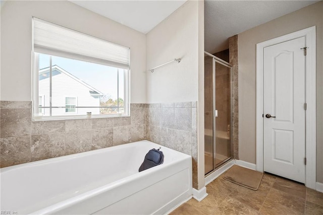 bathroom with separate shower and tub