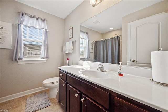 bathroom featuring tile patterned flooring, vanity, and toilet