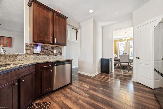 kitchen featuring dark hardwood / wood-style floors, tasteful backsplash, sink, stainless steel dishwasher, and light stone countertops