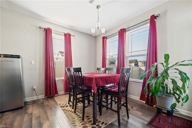 dining room featuring dark wood-type flooring and a chandelier