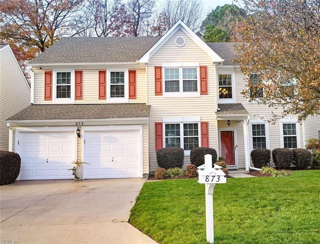 view of front of home with a garage and a front lawn