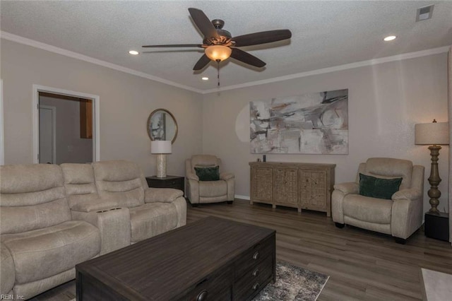 living room with a textured ceiling, ceiling fan, ornamental molding, and dark hardwood / wood-style flooring