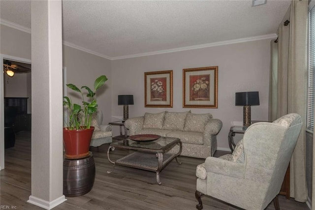 living room with a textured ceiling, ceiling fan, ornamental molding, and wood-type flooring