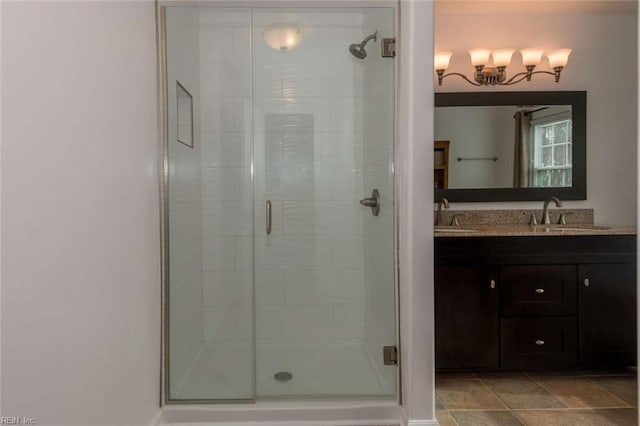 bathroom with a shower with shower door and vanity