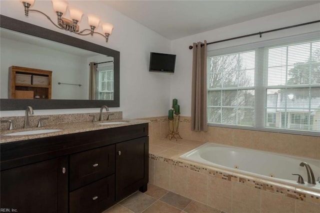 bathroom featuring tiled bath, lofted ceiling, and vanity