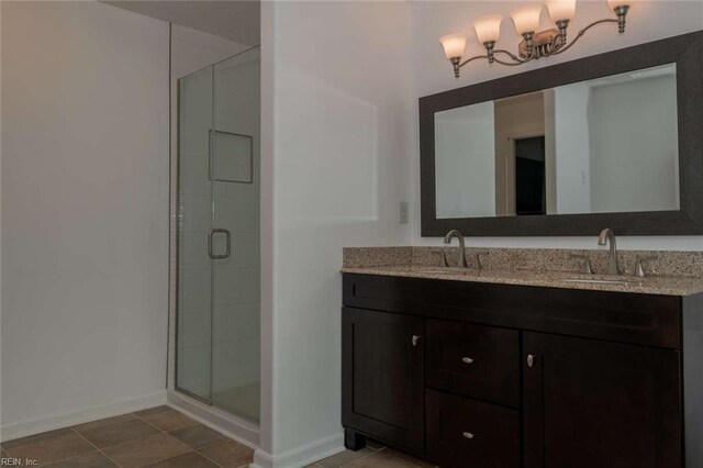 bathroom with vanity and a shower with door