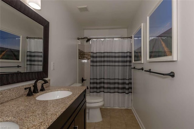 bathroom featuring toilet, vanity, tile patterned flooring, and walk in shower