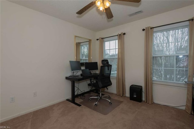 carpeted office with ceiling fan