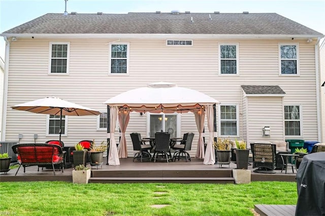 back of house featuring a lawn, a gazebo, a deck, and cooling unit