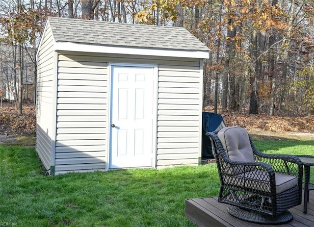 view of outbuilding featuring a lawn