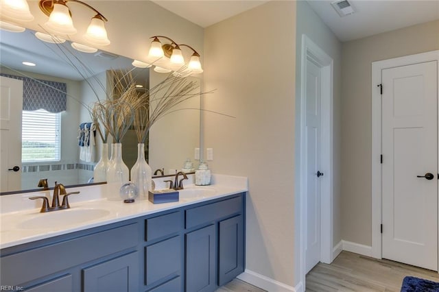 bathroom with hardwood / wood-style floors and vanity