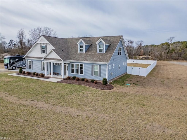 cape cod house with a front yard