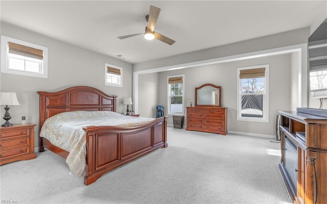 bedroom with ceiling fan and light colored carpet