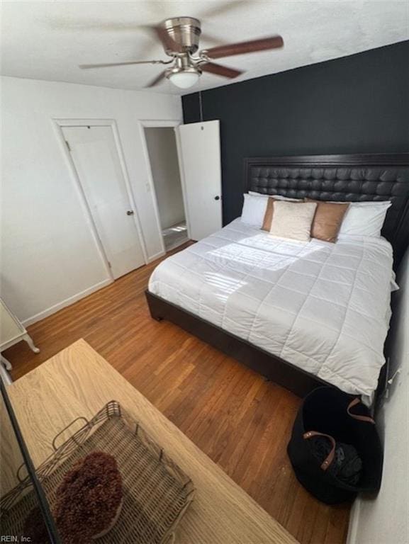 bedroom with ceiling fan and hardwood / wood-style floors