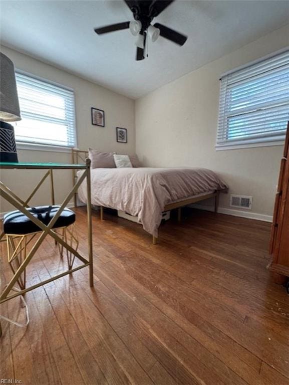 bedroom featuring ceiling fan and dark hardwood / wood-style floors