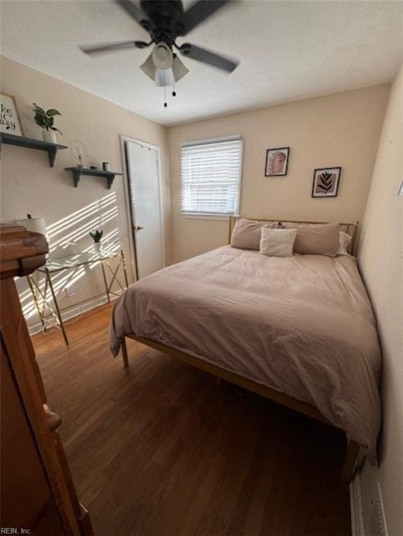 bedroom with ceiling fan and hardwood / wood-style flooring