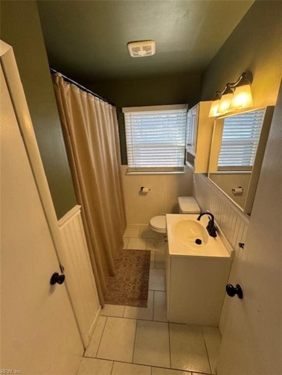 bathroom with tile patterned floors, vanity, and toilet