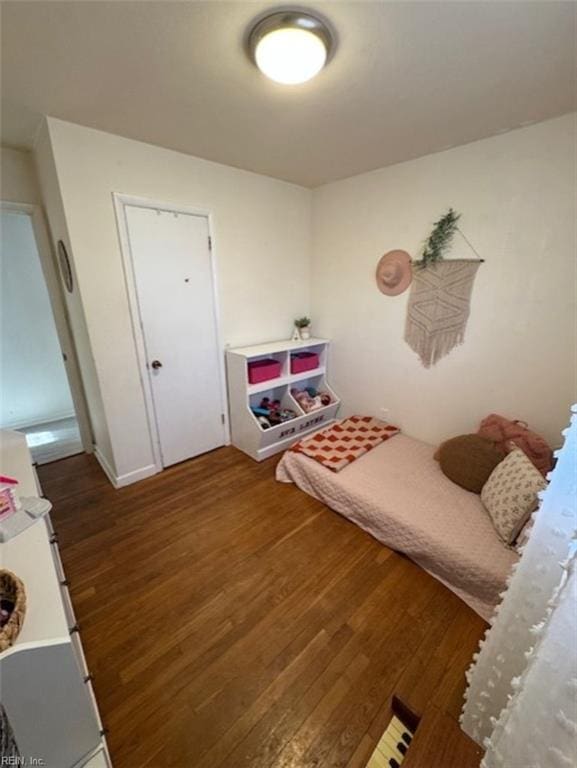 bedroom with dark wood-type flooring