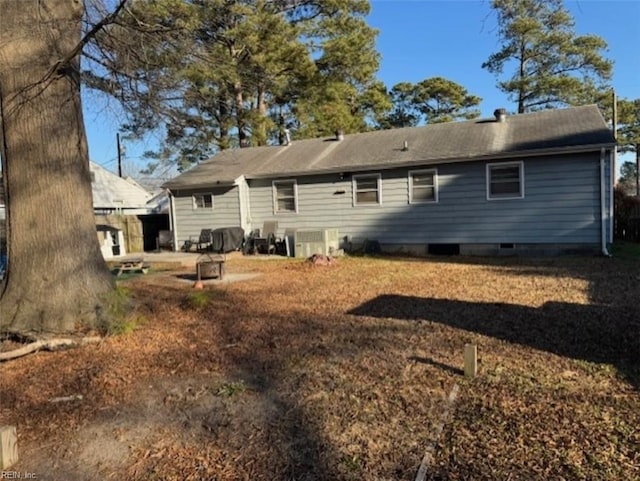 rear view of house featuring central air condition unit