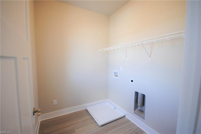 clothes washing area featuring wood-type flooring, washer hookup, and hookup for an electric dryer