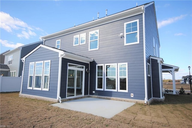 back of house featuring a patio area and a yard