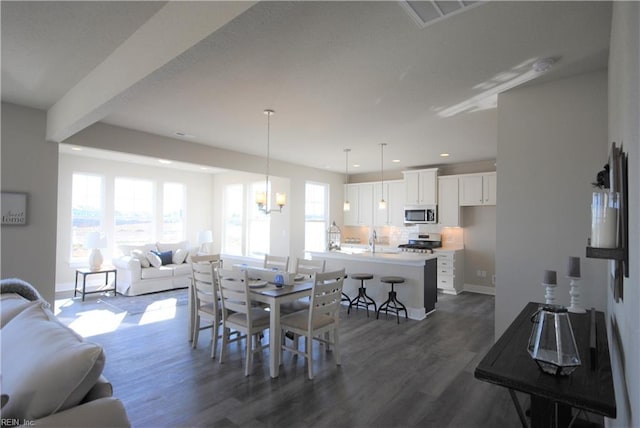 dining room featuring dark hardwood / wood-style flooring, a chandelier, and sink