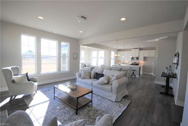 living room featuring a wealth of natural light and dark hardwood / wood-style floors