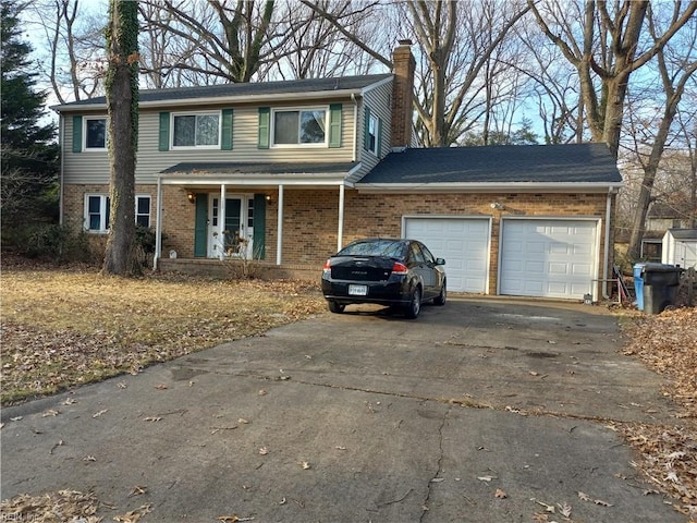 view of property with a garage and a porch