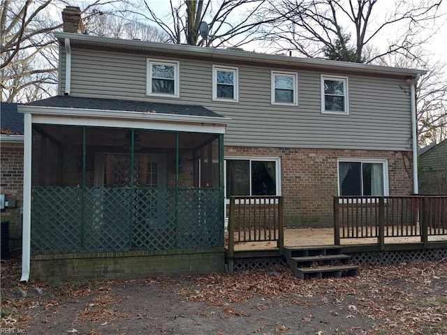 rear view of house with a deck and a sunroom