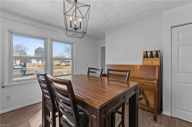 dining room featuring hardwood / wood-style floors and a notable chandelier