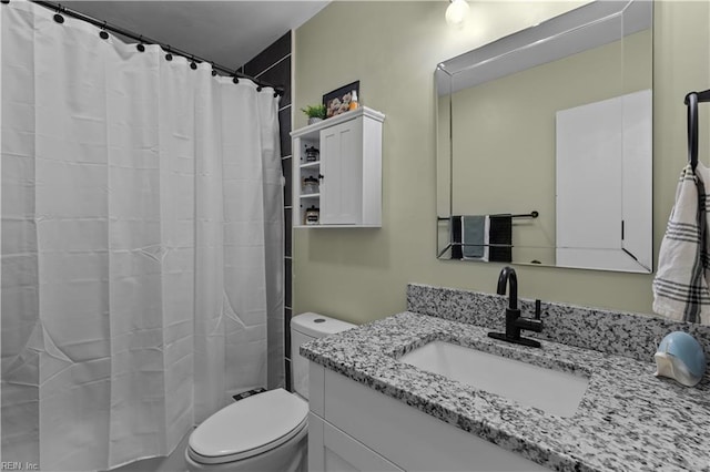 bathroom featuring toilet, walk in shower, and vanity