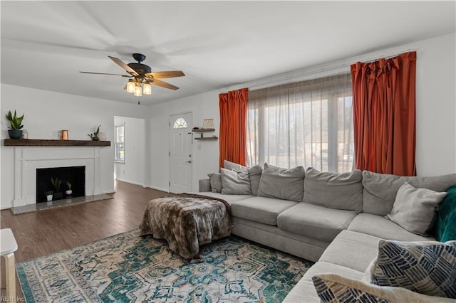 living room featuring ceiling fan, a wealth of natural light, and dark hardwood / wood-style flooring