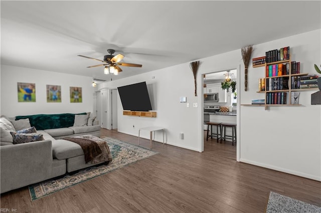 living room with ceiling fan and dark hardwood / wood-style floors