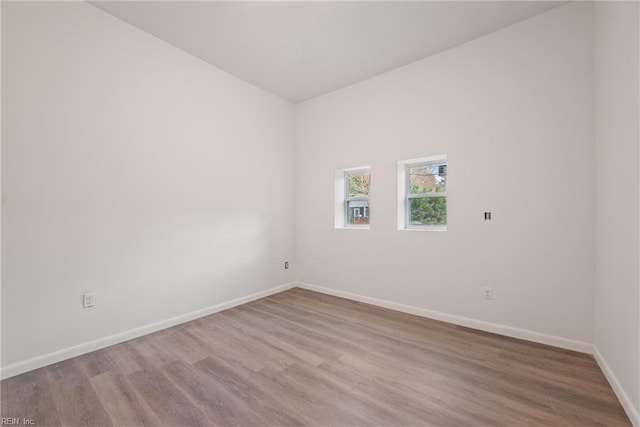 empty room with hardwood / wood-style flooring