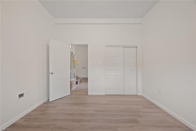 interior space featuring light wood-type flooring and a closet