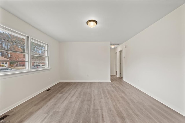 spare room featuring light wood-type flooring