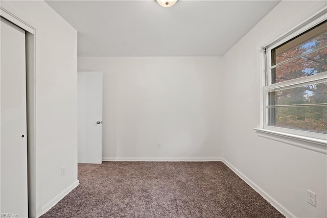 unfurnished bedroom with carpet floors and a closet