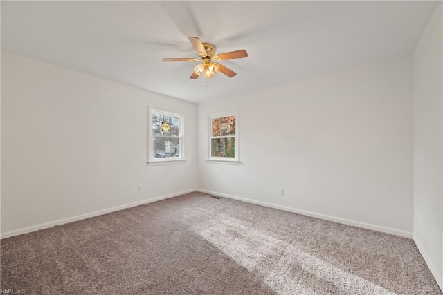 empty room with ceiling fan and carpet flooring