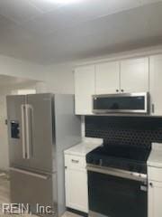 kitchen featuring white cabinetry and appliances with stainless steel finishes