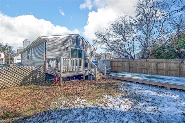 back of house featuring a wooden deck