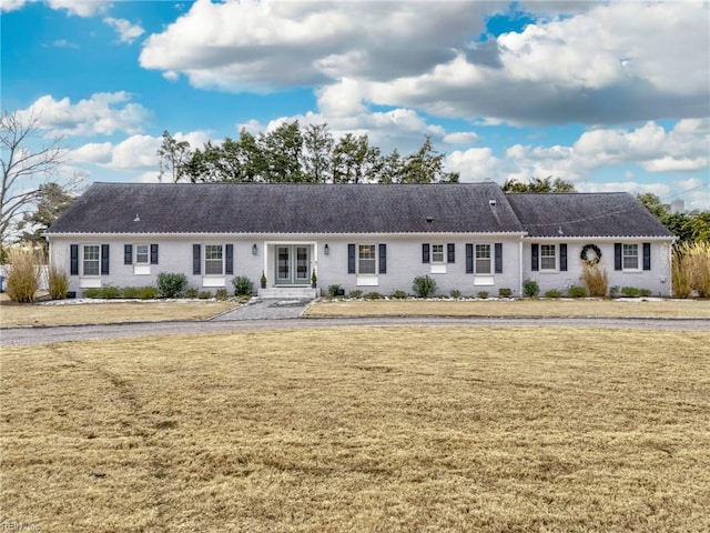 ranch-style house featuring a front lawn and french doors