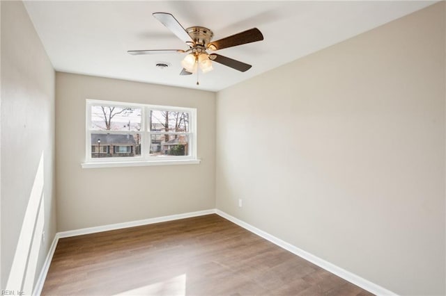 empty room featuring ceiling fan and hardwood / wood-style flooring