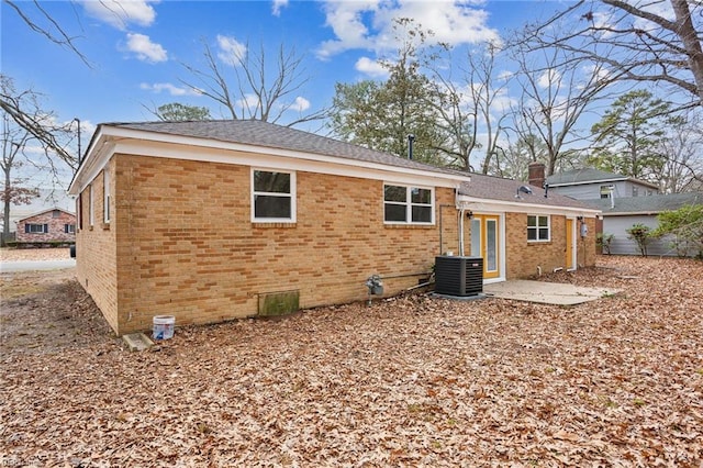 rear view of property with a patio area and central air condition unit