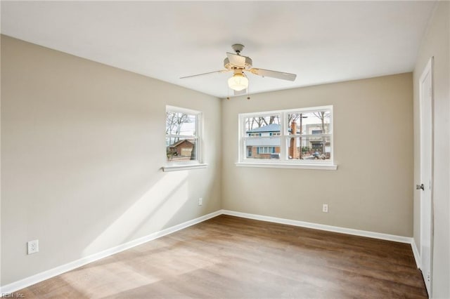 unfurnished room with ceiling fan and hardwood / wood-style floors