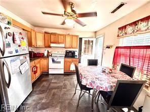 kitchen featuring ceiling fan, stainless steel fridge, and white range with electric cooktop