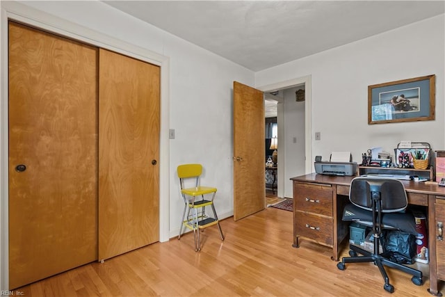 home office with light hardwood / wood-style floors