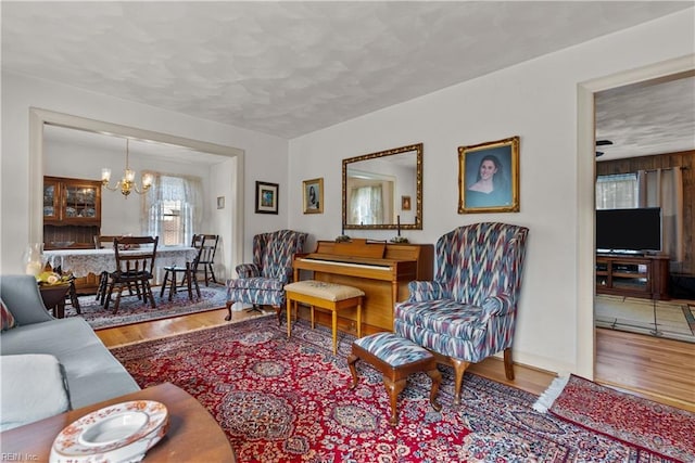 living room featuring an inviting chandelier and hardwood / wood-style floors