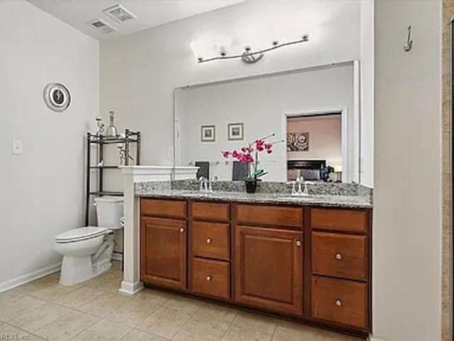 bathroom with tile patterned floors, toilet, vanity, and an enclosed shower