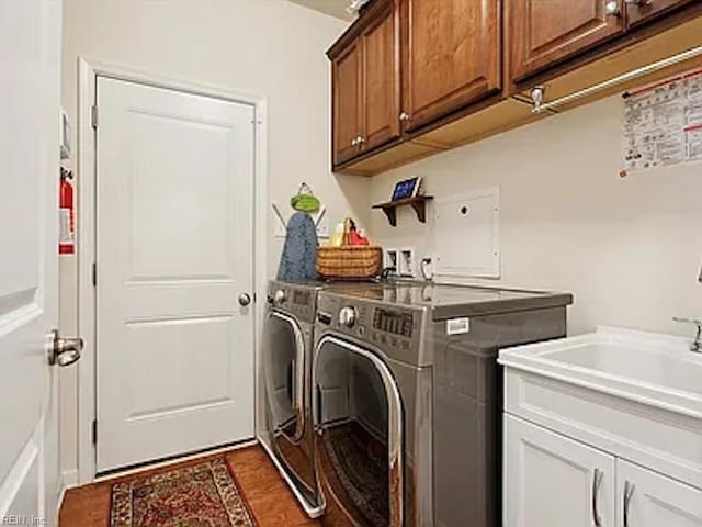 laundry area with washer and clothes dryer and cabinets