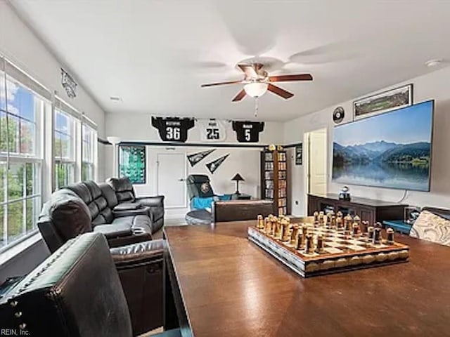 living room featuring ceiling fan and plenty of natural light